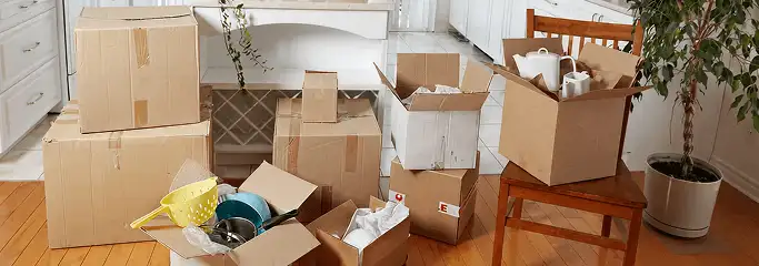 Packed moving boxes and household items in a kitchen before move-out or move-in cleaning, Clearwater, FL.